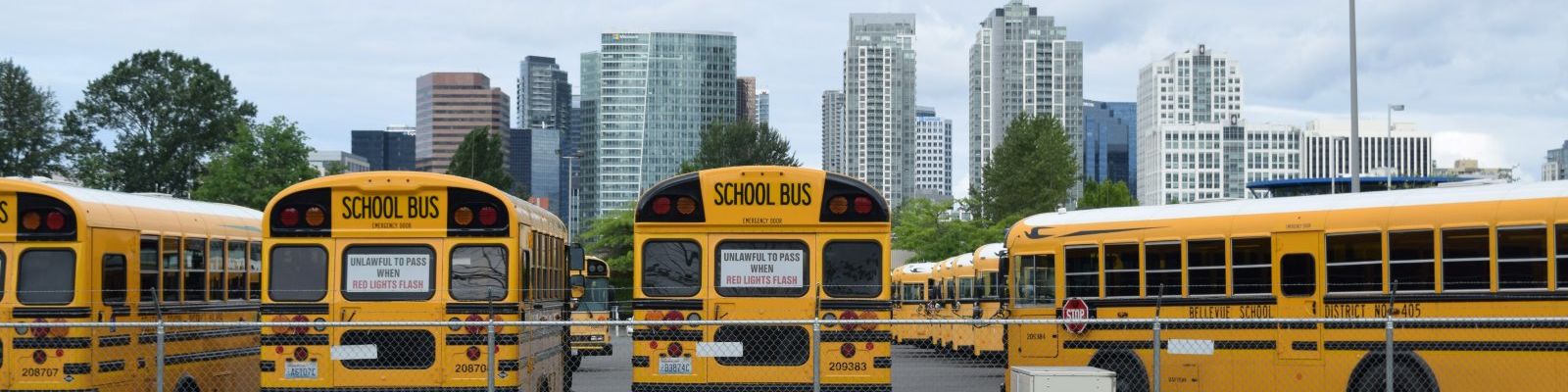 Image of Bellevue school buses with downtown skyline in background