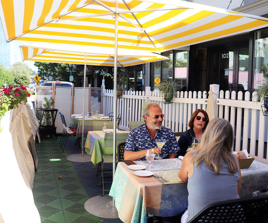 John and Carla Stratfold dine at Bis on Main's al fresco space with their friend Stacy Graven (back to camera).