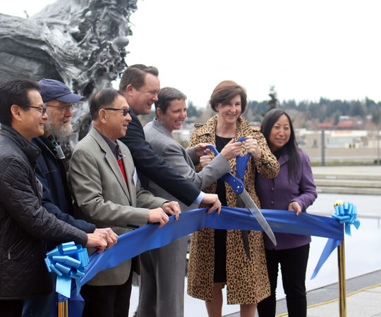 City Council members, City Manager Brad Miyake and Sound Transit CEO Julie Timm clip the ribbon for the reopening of the City Hall plaza.