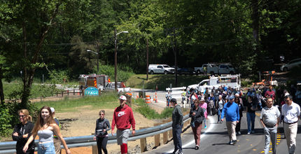 People walk toward the new Lakemont Boulevard bridge before the grand opening.
