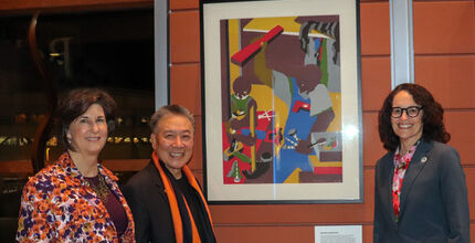 From left, Mayor Lynne Robinson, Jerry Lee and City Manager Diane Carlson stand next to the Jacob Lawrence artwork that Lee donated to the city.