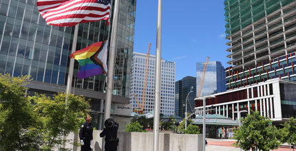 The Honor Guard raises the pride flag at City Hall.