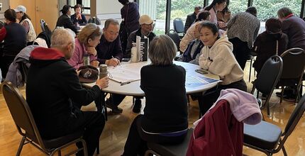 People sit around tables, talking.