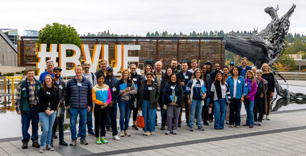 A Bellevue Essentials class stands together on the City Hall plaza.