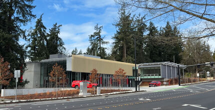 Fire station in front of evergreens