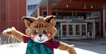Belle the Bobcat, the city mascot, stands in front of City Hall.