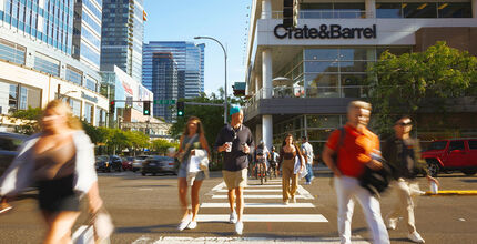 Shoppers walk across Northeast Eighth Street downtown.