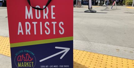 The rewritten sign code covers temporary signs as well, like this sandwich board calling for artists at the downtown arts market.