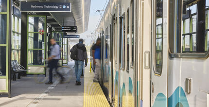 People board the 2 Line at the 130th Street station.