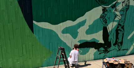 A man paints a mural.
