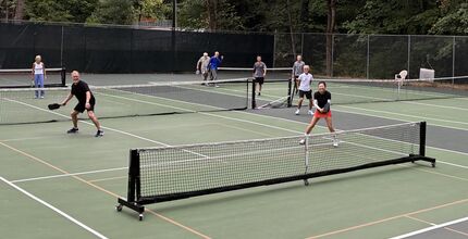 People play pickleball on outdoor pickleball court.