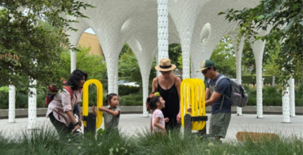 A family plays by the grant-funded Piloti sculpture at Downtown Park.