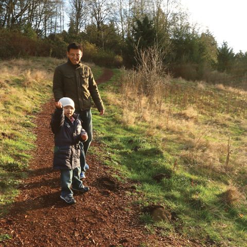 father and son on a path in a field
