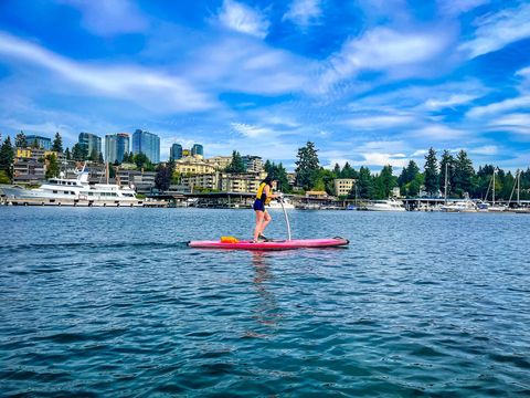 image of woman on red peddle board on the lake at Meydenbauer Bay Park