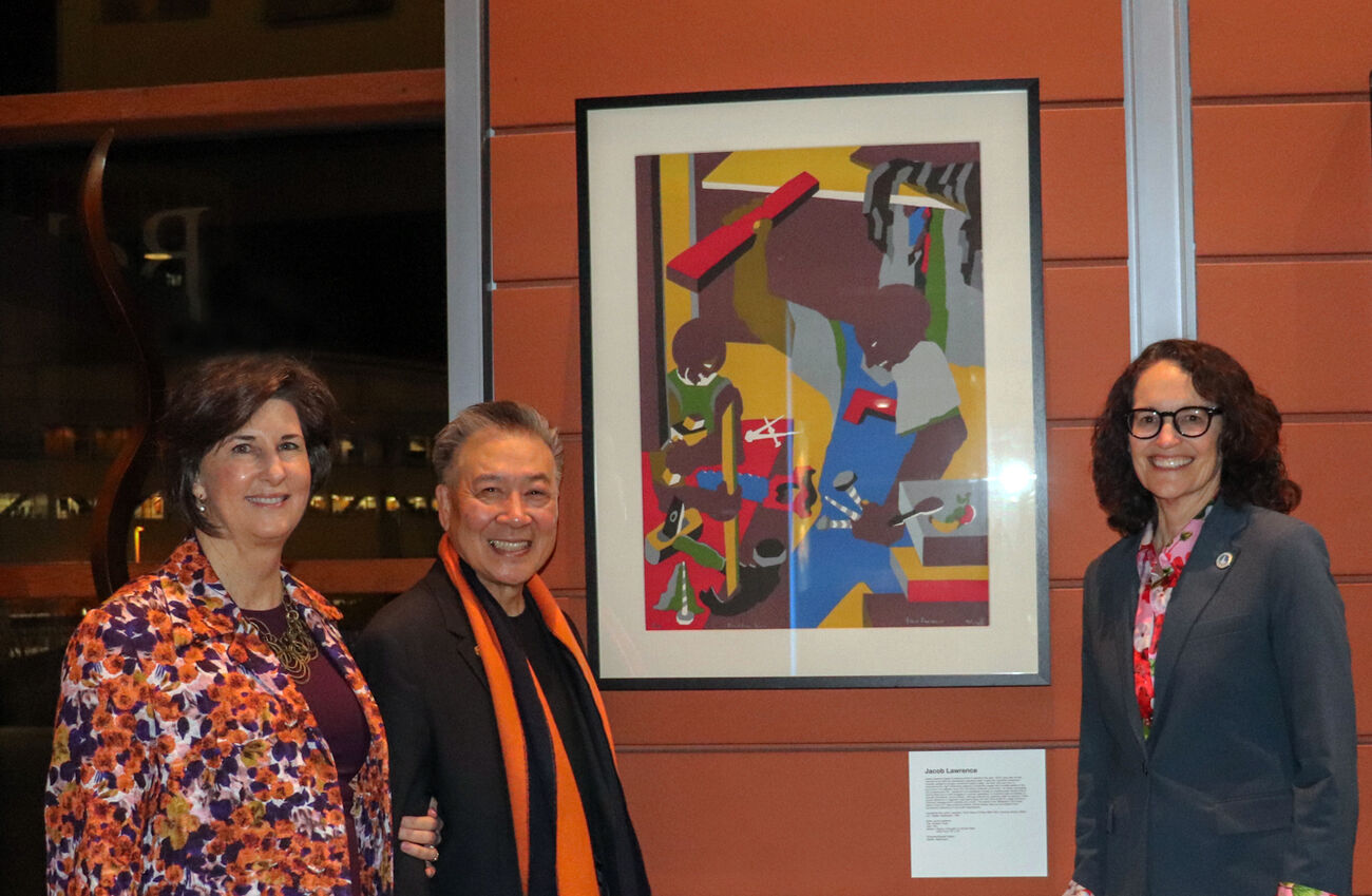 From left, Mayor Lynne Robinson, Jerry Lee and City Manager Diane Carlson stand next to the Jacob Lawrence artwork that Lee donated to the city.