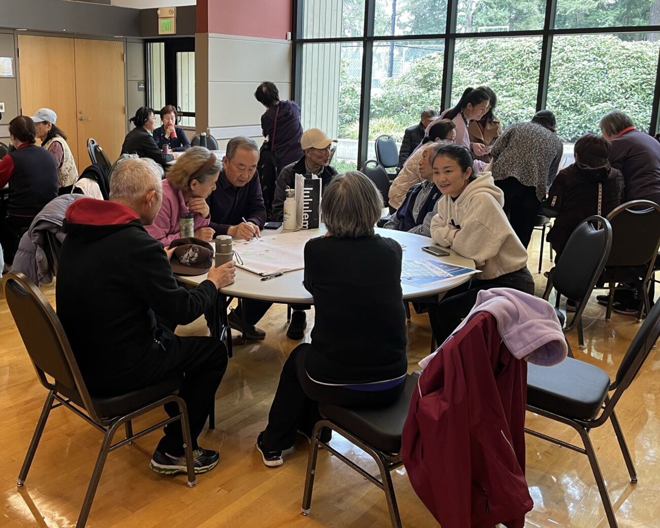 People sit around tables, talking.