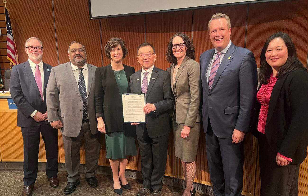 Councilmember Conrad Lee, center, accepts a commendation for his many years on the council.