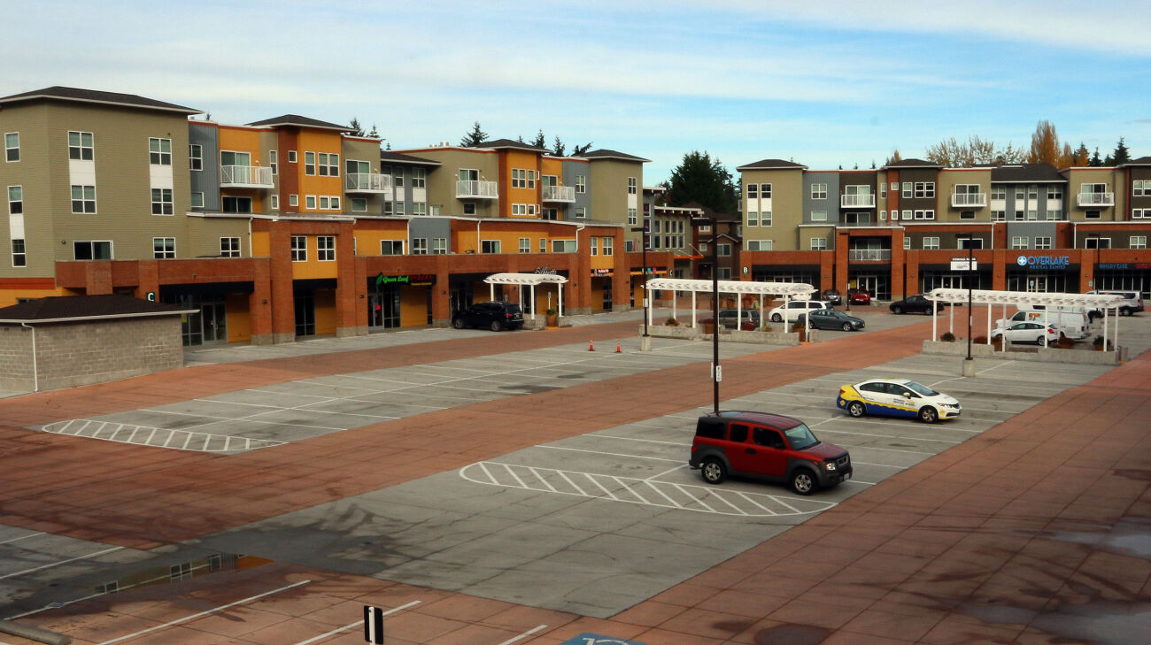 There are many empty parking stalls at a Bellevue shopping center.
