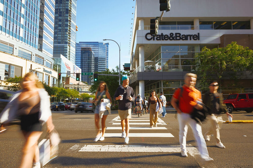 Shoppers walk across Northeast Eighth Street downtown.