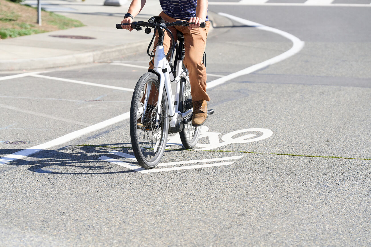 A person rides an e-bike on a Bellevue street.