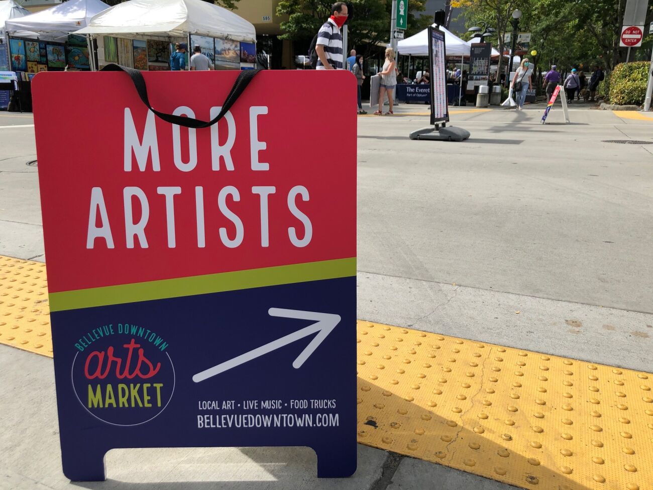 The rewritten sign code covers temporary signs as well, like this sandwich board calling for artists at the downtown arts market.