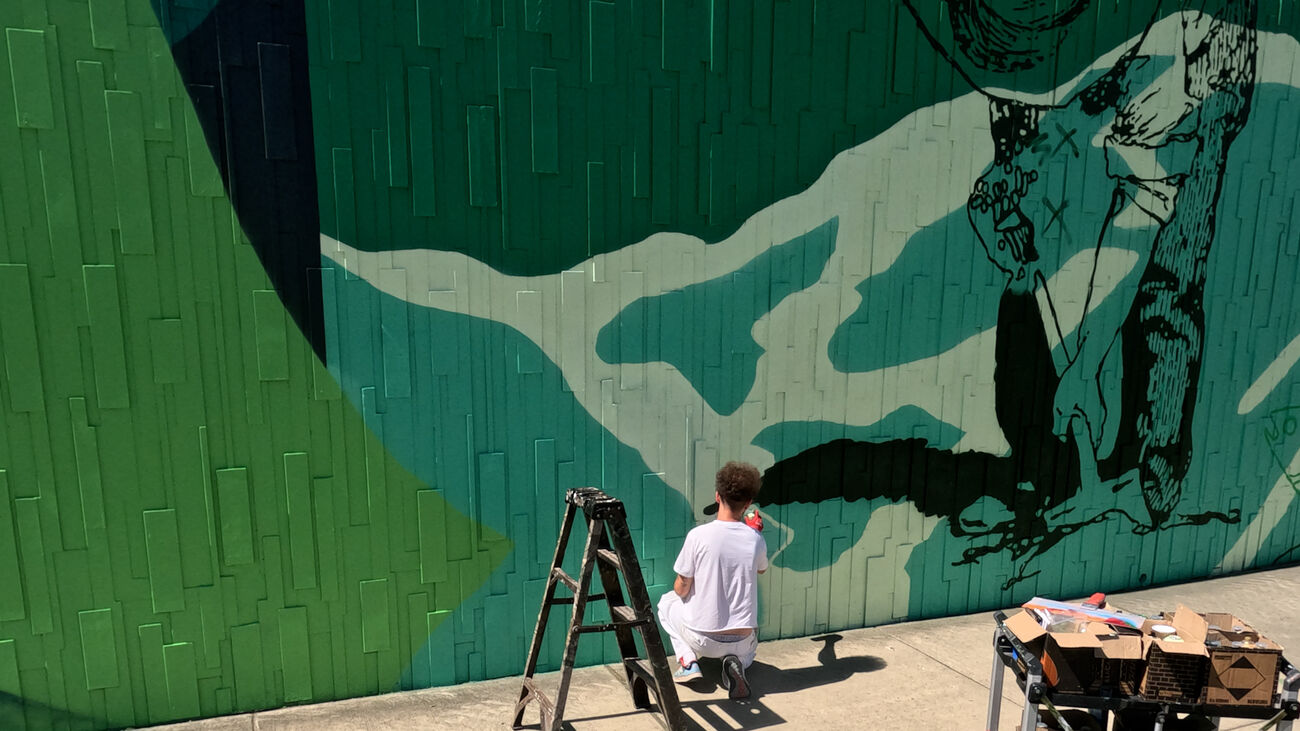 A man paints a mural.