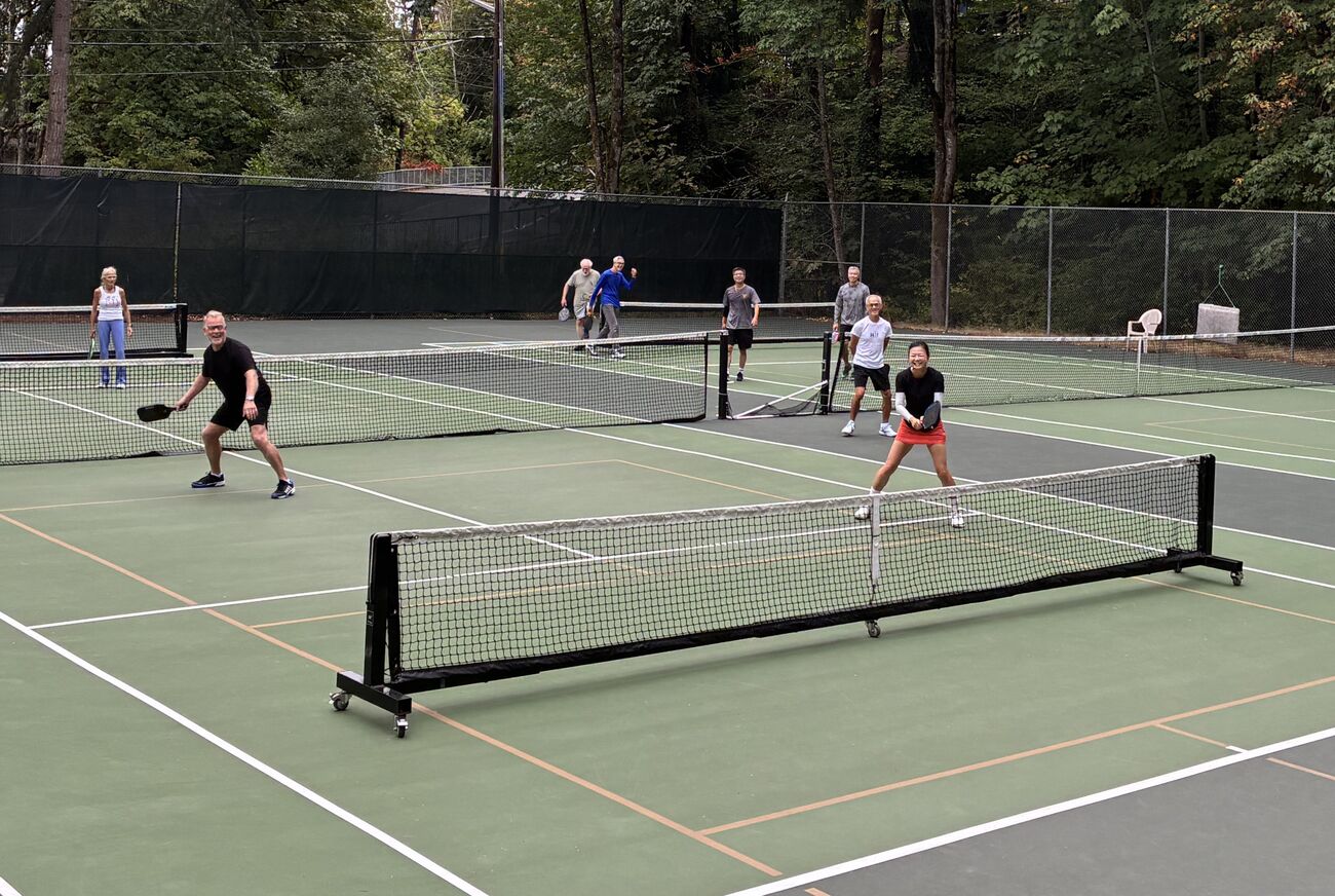People play pickleball on outdoor pickleball court.