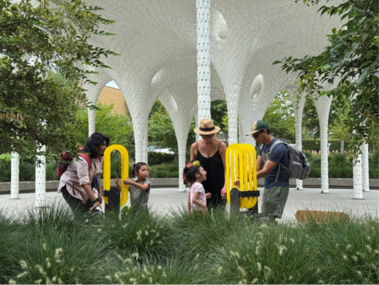 A family plays by the grant-funded Piloti sculpture at Downtown Park.