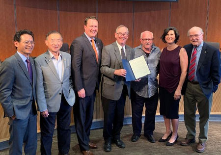 Jim McEachran accepts a commendation from the City Council
