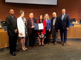 Councilmembers Conrad Lee and Janice Zahn hold the proclamation issued by the City Council celebrating AANHPI Heritage Month.