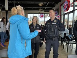 Image of Bellevue Police Department officers and staff speaking with community members during "Coffee with a Cop" events.