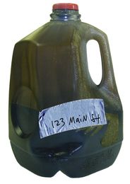 Used motor oil in milk jug
