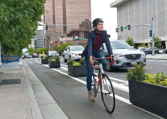 image of person bicycling in downtown on 108th Avenue Northeast