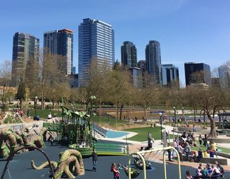 Image of downtown Bellevue with a playground in Downtown Park in the foreground.