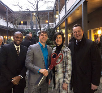 From left, Councilmember Jeremy Barksdale, Congregations for the Homeless Executive Director David Bowling, Mayor Lynne Robinson and Deputy Mayor Jared Nieuwenhuis celebrate the opening of the Lincoln Center temporary shelter in January 2020, after needed improvements. 