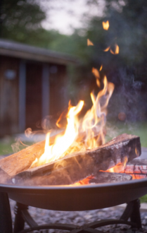 Image of portable firepit with a campfire blazing. 