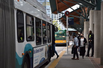 People board a bus at the Bellevue Transit Center.