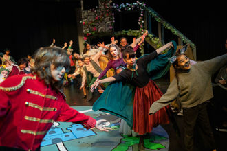 image of group of children performing a play on stage at Bellevue Youth Theatre