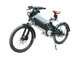Electric motorcycle leaning on a kickstand. It has two wheels, a front headlight and an orange seat. 