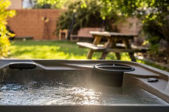 Image of a private backyard hot tub with bubbling water from the jets.