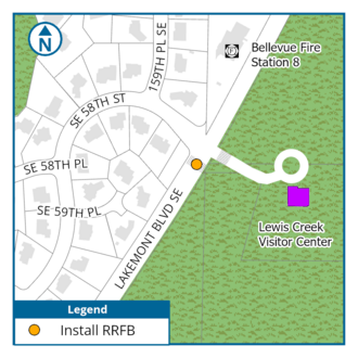 A map showing the area around Lakemont Boulevard SE near Lewis Creek Visitor Center. Residential streets including SE 58th Street, SE 58th Place, SE 59th Place, and 159th Place SE appear on the left side. Bellevue Fire Station 8 is marked near the top right. A circular driveway leads to the Lewis Creek Visitor Center, represented by a purple square. A pedestrian crossing with an orange dot—indicating the planned installation of a Rectangular Rapid Flashing Beacon (RRFB)—is located along Lakemont Boulevard S