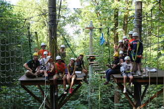 Participants on the high ropes course at the Bellevue Challe