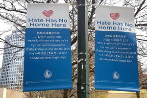 Two hate has no home her banners hanging from a pole