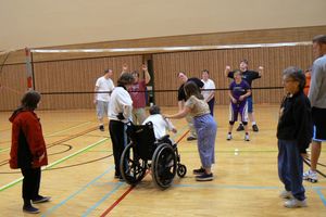 image of a group of people playing volleyball indoors