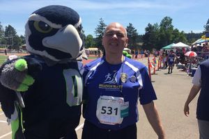 Highland Community Center - Image of HCC participant posing with Seahawks mascot.