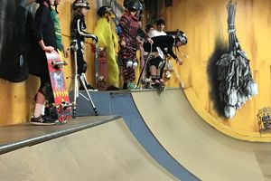 group of youth at top of skate ramp, dressed in costumes for Halloween