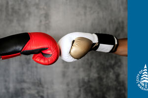 Two separate boxing gloves meeting in the center, depicting two boxers touching gloves before a match. The boxing glove on the right is red and black. The boxing glove on the right is white, gold and black.