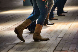 A closeup shot of the legs of traditional western folk dancing under the music