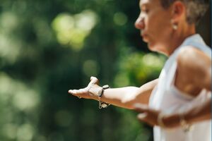 woman practicing tai chi outdoors