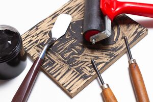 Image of block printing hand tools and carved matrix. 